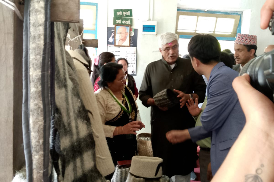 Union Minister and delegates inspecting woollen products